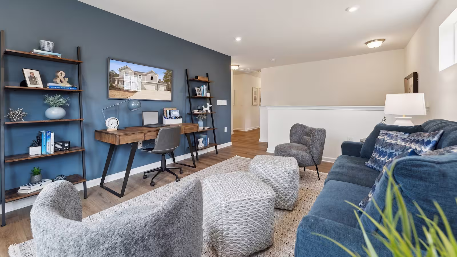 Loft in a single-family home by HHHunt Homes at Charlotte's Ridge featuring a blue accent wall and couch