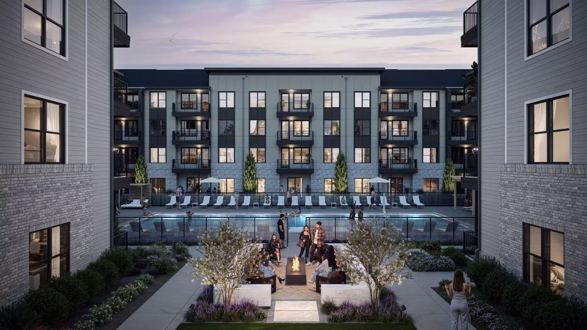 A rendering of an apartment building with a hangout spot where people are sitting.