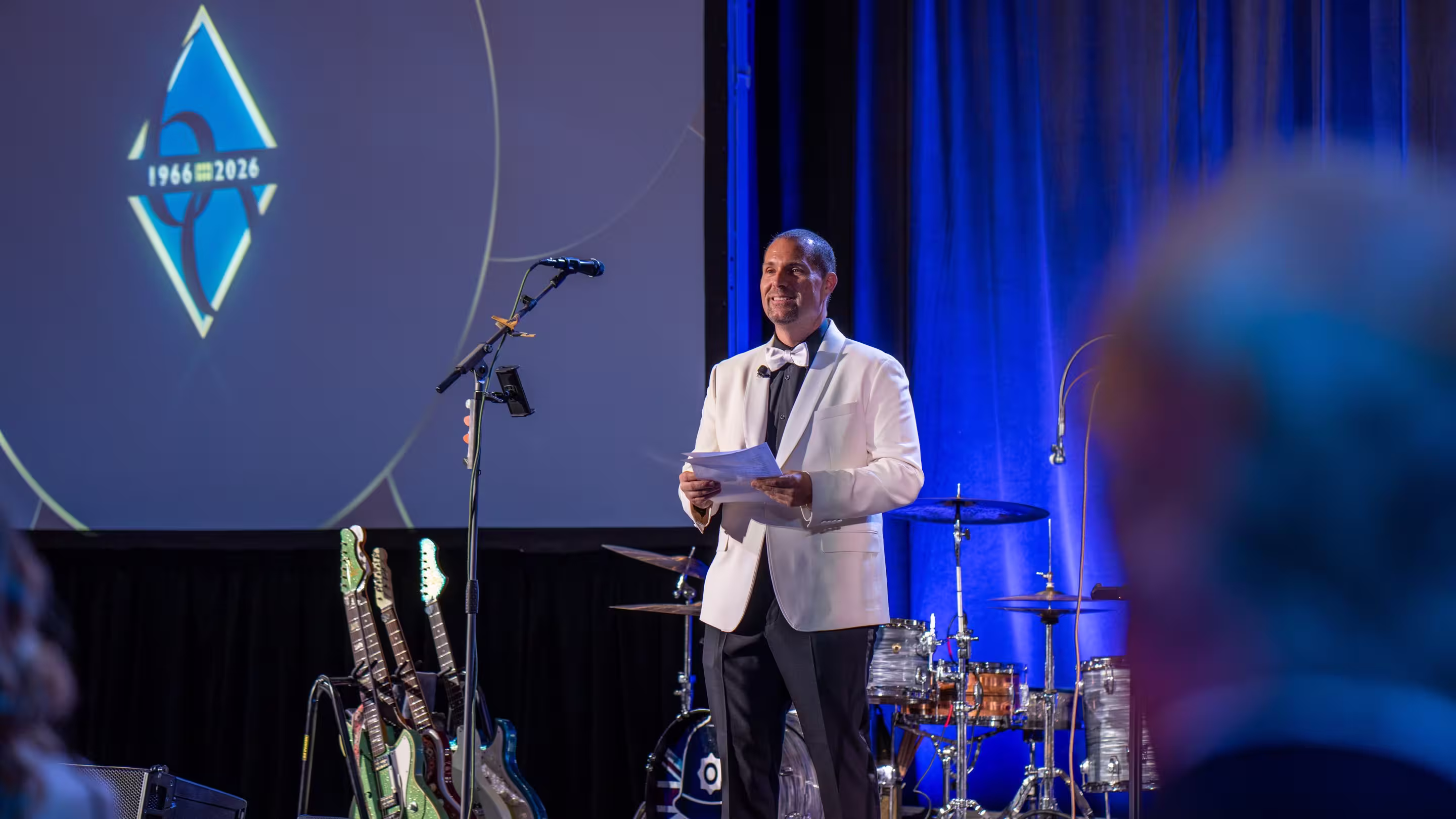 CEO standing on the stage giving the audience a message.