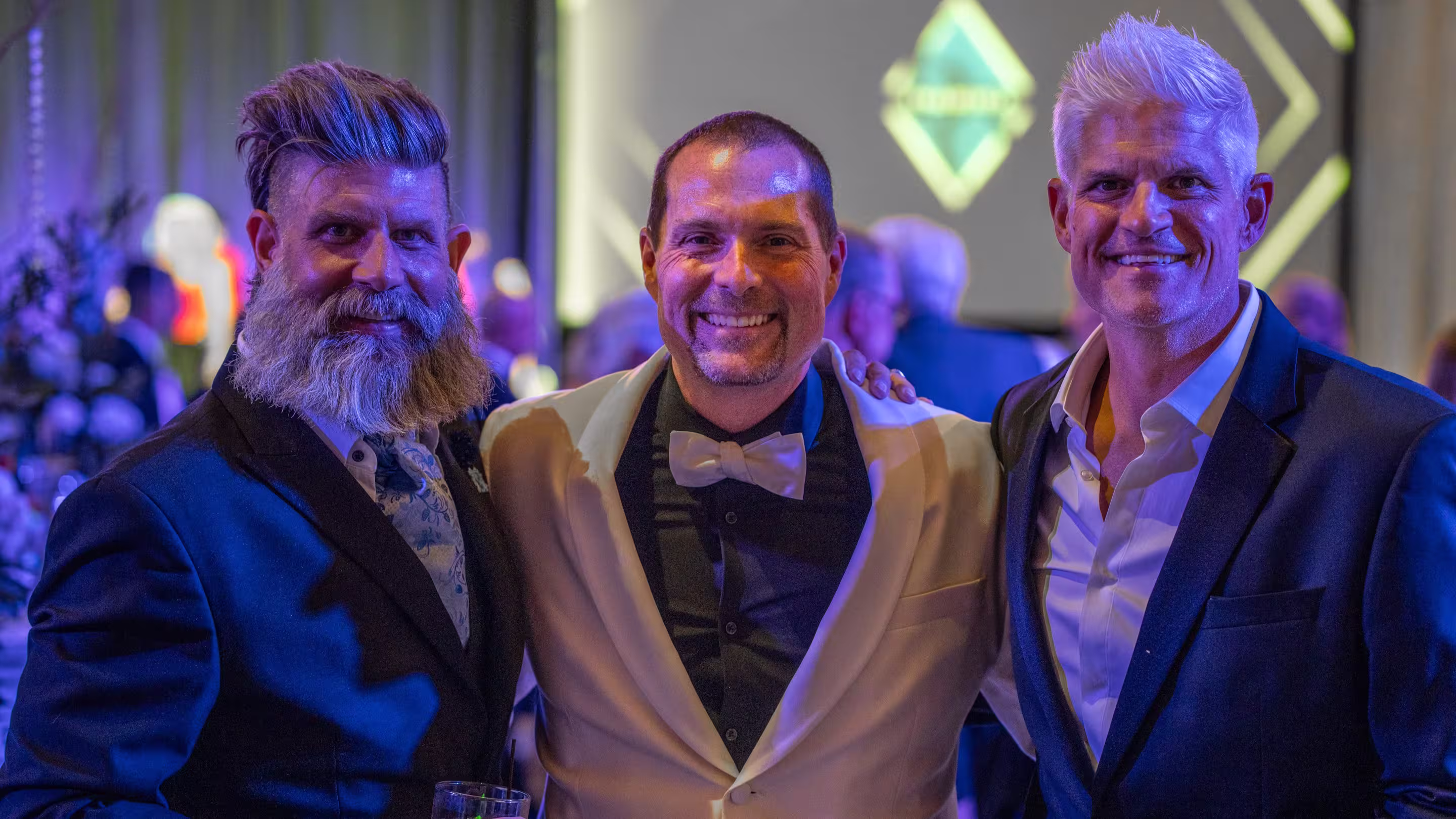 Three men standing and posing for a photo.