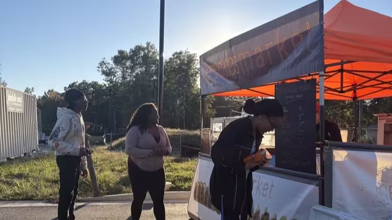 People standing by an empanada food truck.