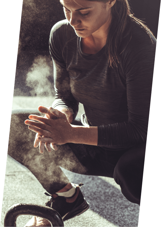 Female mesomorph powdering her hands before a workout