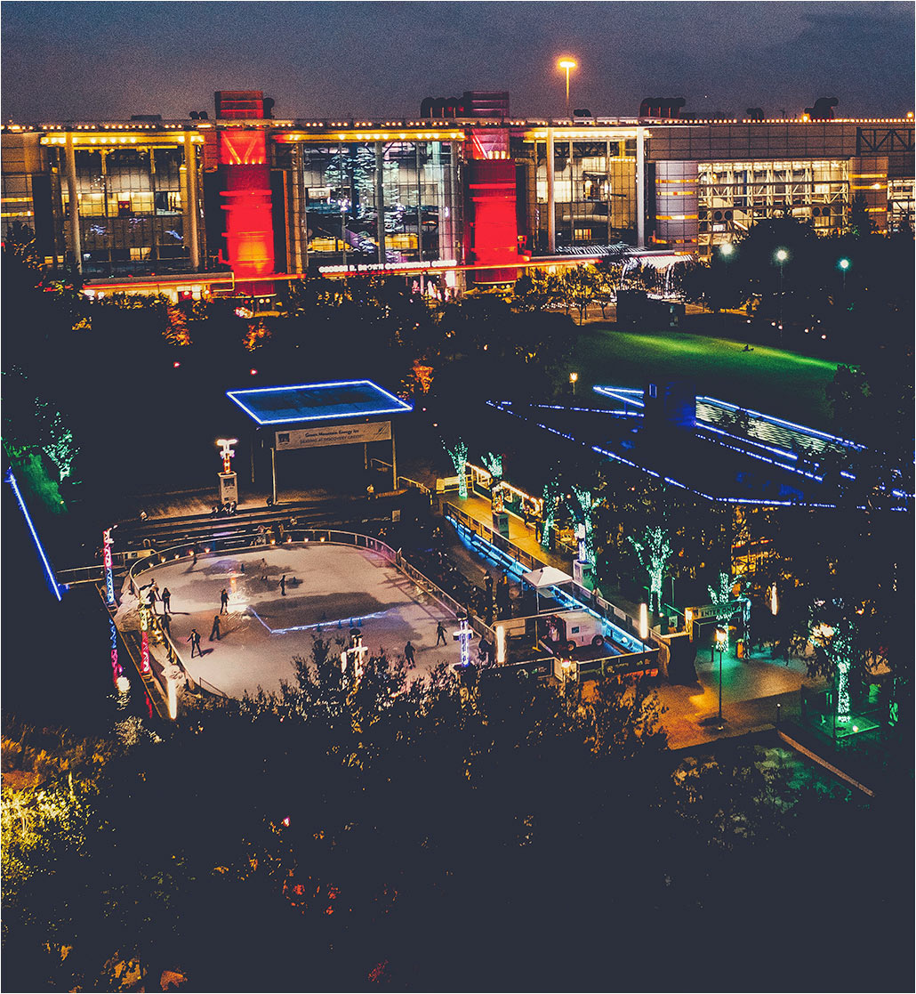 Nighttime aerial photo of Houston park area illuminated with lights and crowds