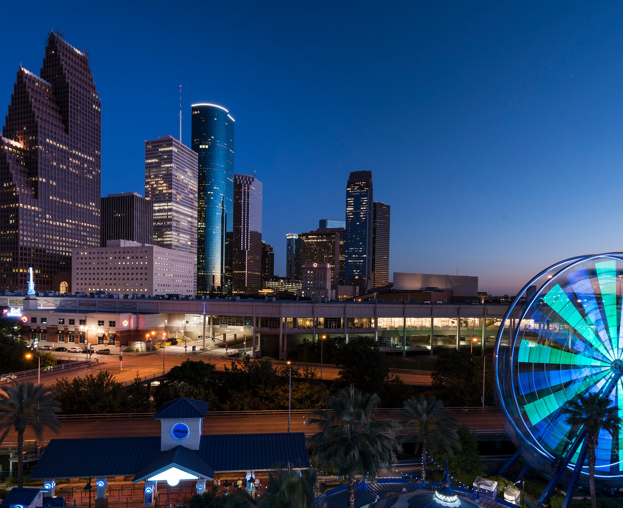 Dusk shot of Houston, taken from the Downtown Aquarium. The spinning wheel at the right is the aquarium's Ferris wheel