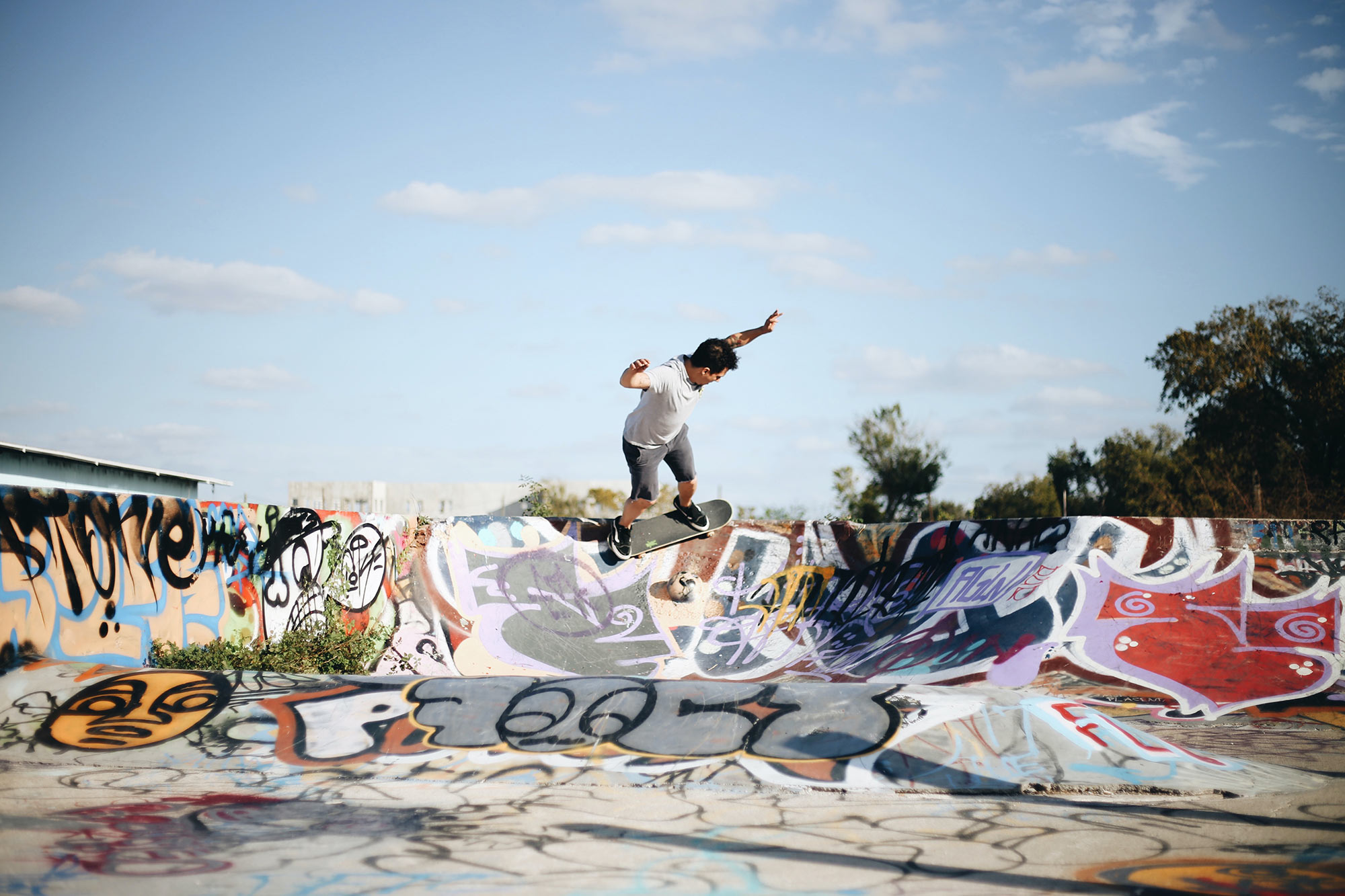 Skateboarder is executing aerial trick in outdoor skatepark