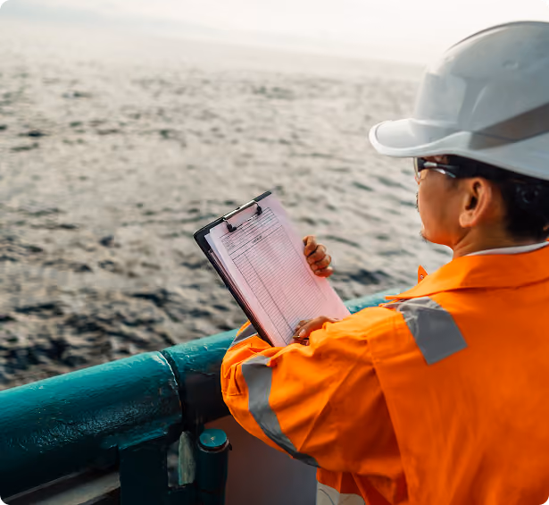 a marine looking to the ocean while inside the ship