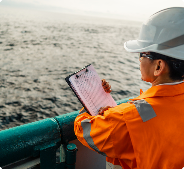 a marine looking to the ocean while inside the ship