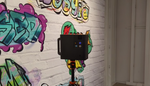 a Matterport camera with mural in the background