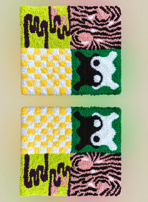 An image of a tufted wall hanging commissioned for a home studio. It is four square panels with a different design in each