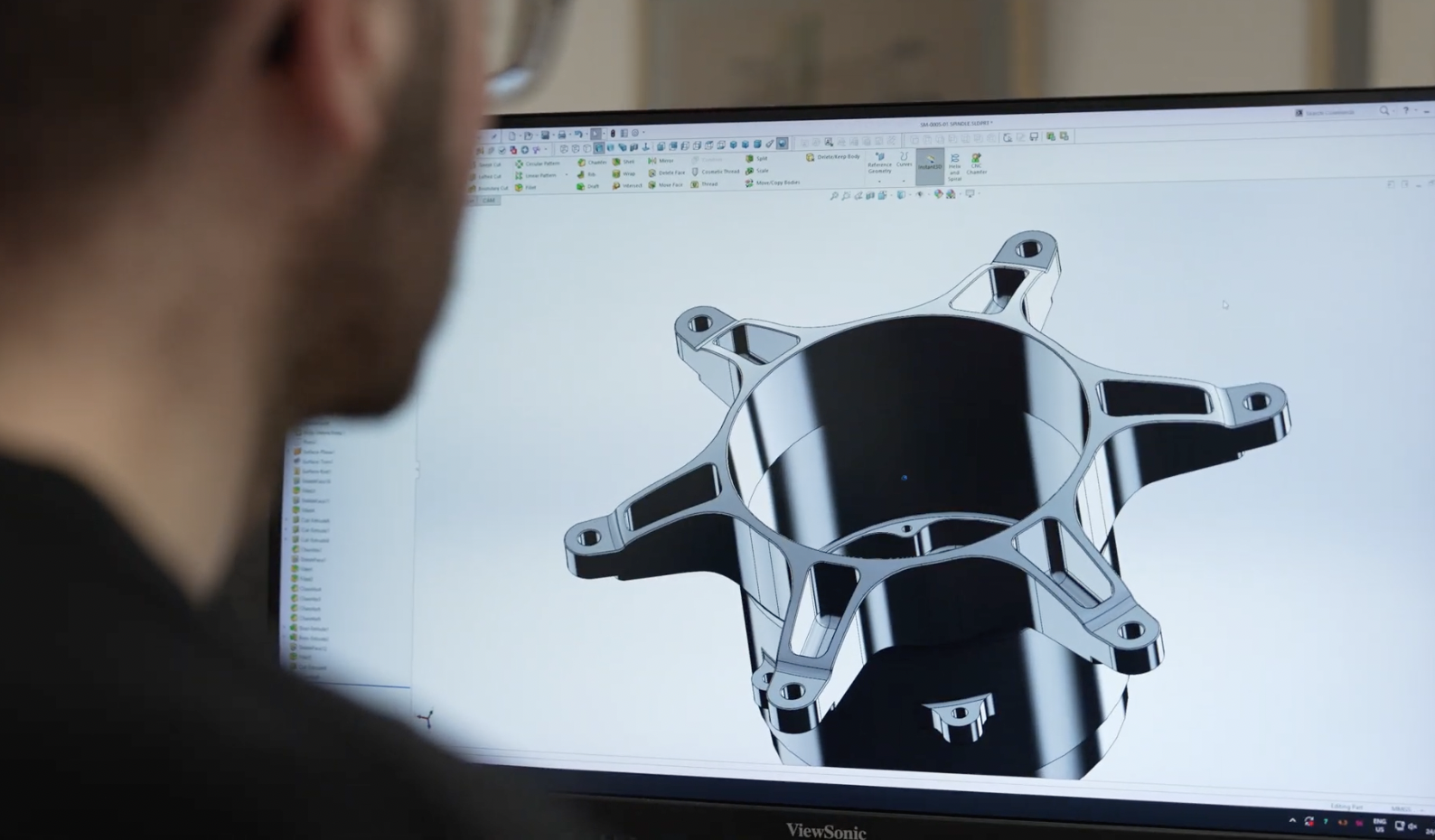 Engineer reviewing a CAD model on screen
