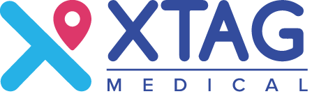 XTAG Medical logo featuring a blue stylized X with a pink location pin at the top left, and the text 'XTAG MEDICAL' in blue.