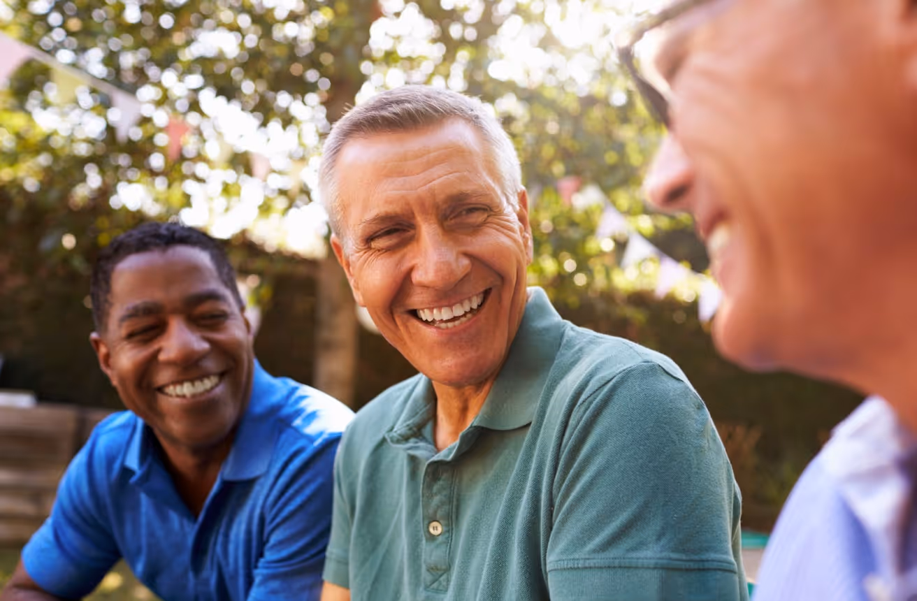 Group of smiling middle-aged men enjoying time together outdoors