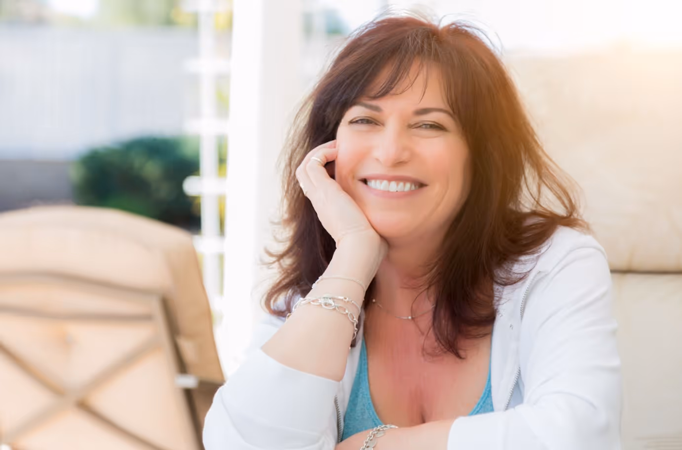 Smiling middle-aged woman outdoors, representing confidence and wellness after hormone therapy