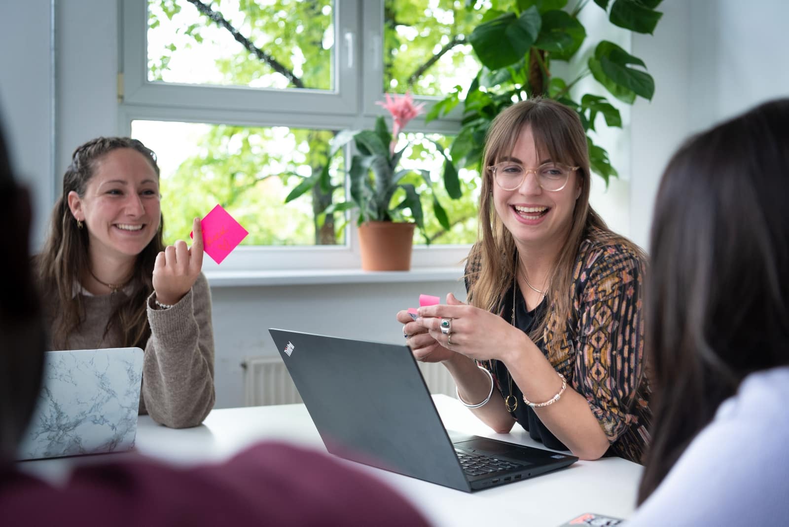 a men and a woman from the design company LAUDO discuss their project on the computer screen