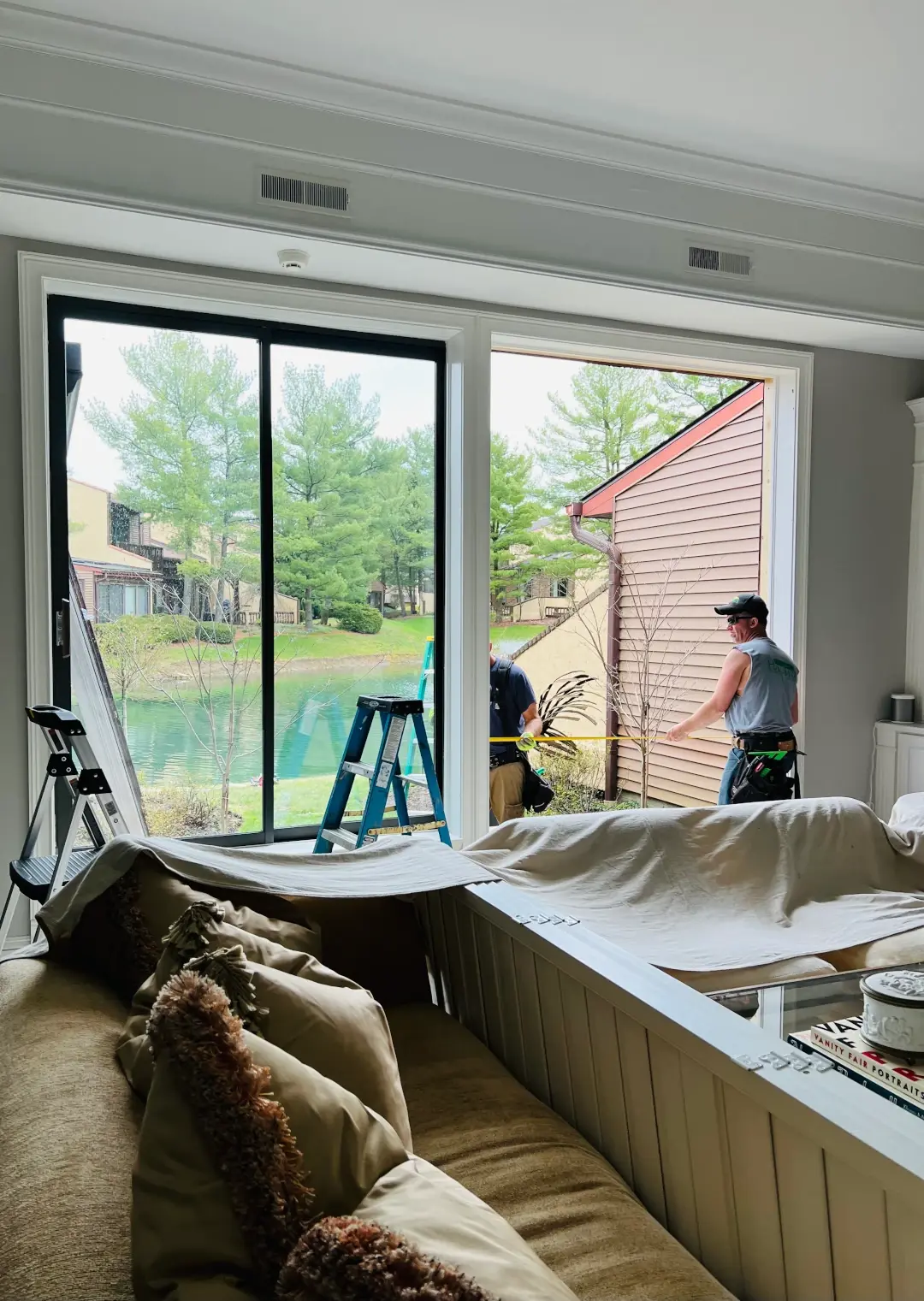workers taking door measurements