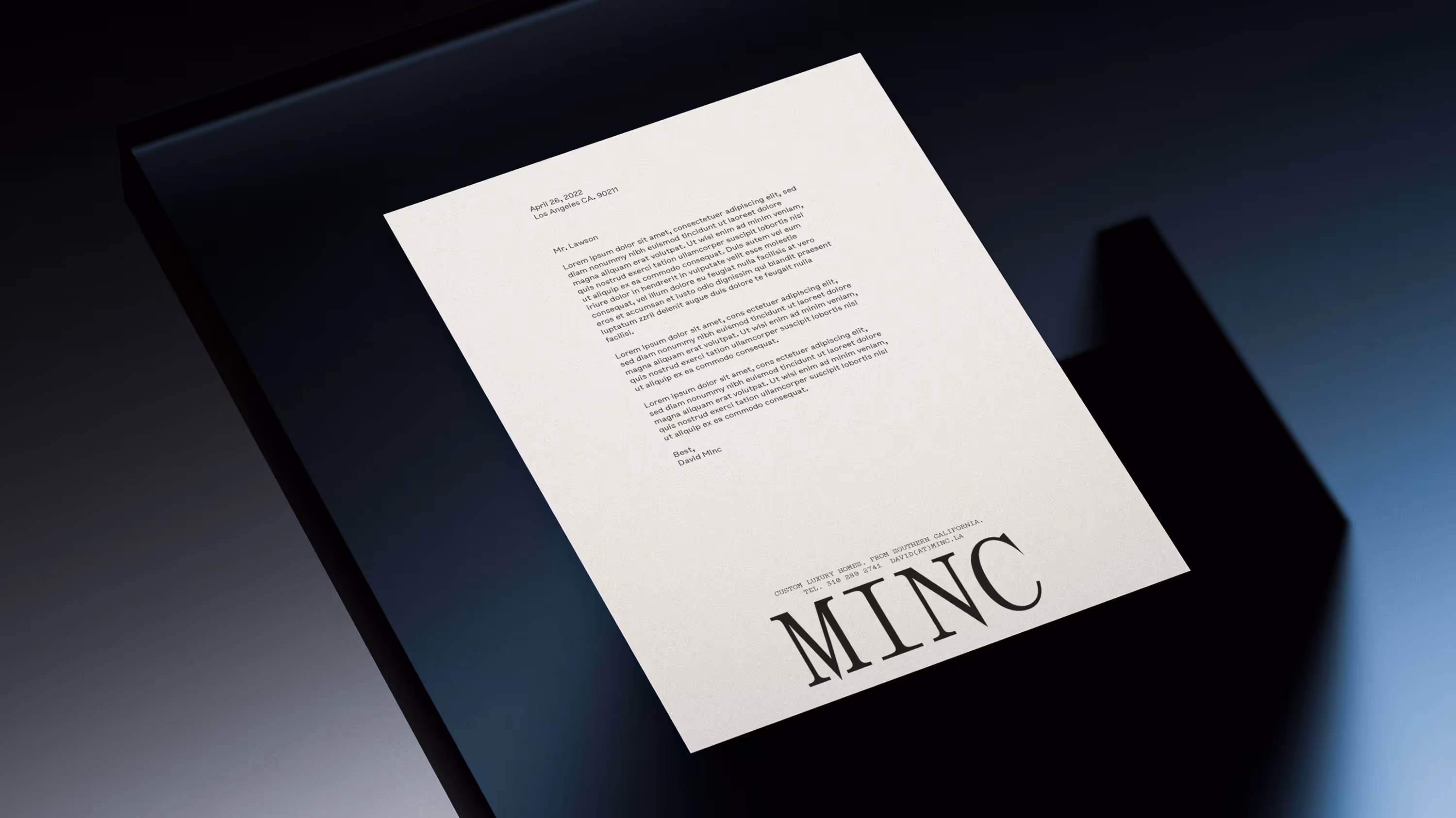 A Minc-branded letterhead on a glass table.