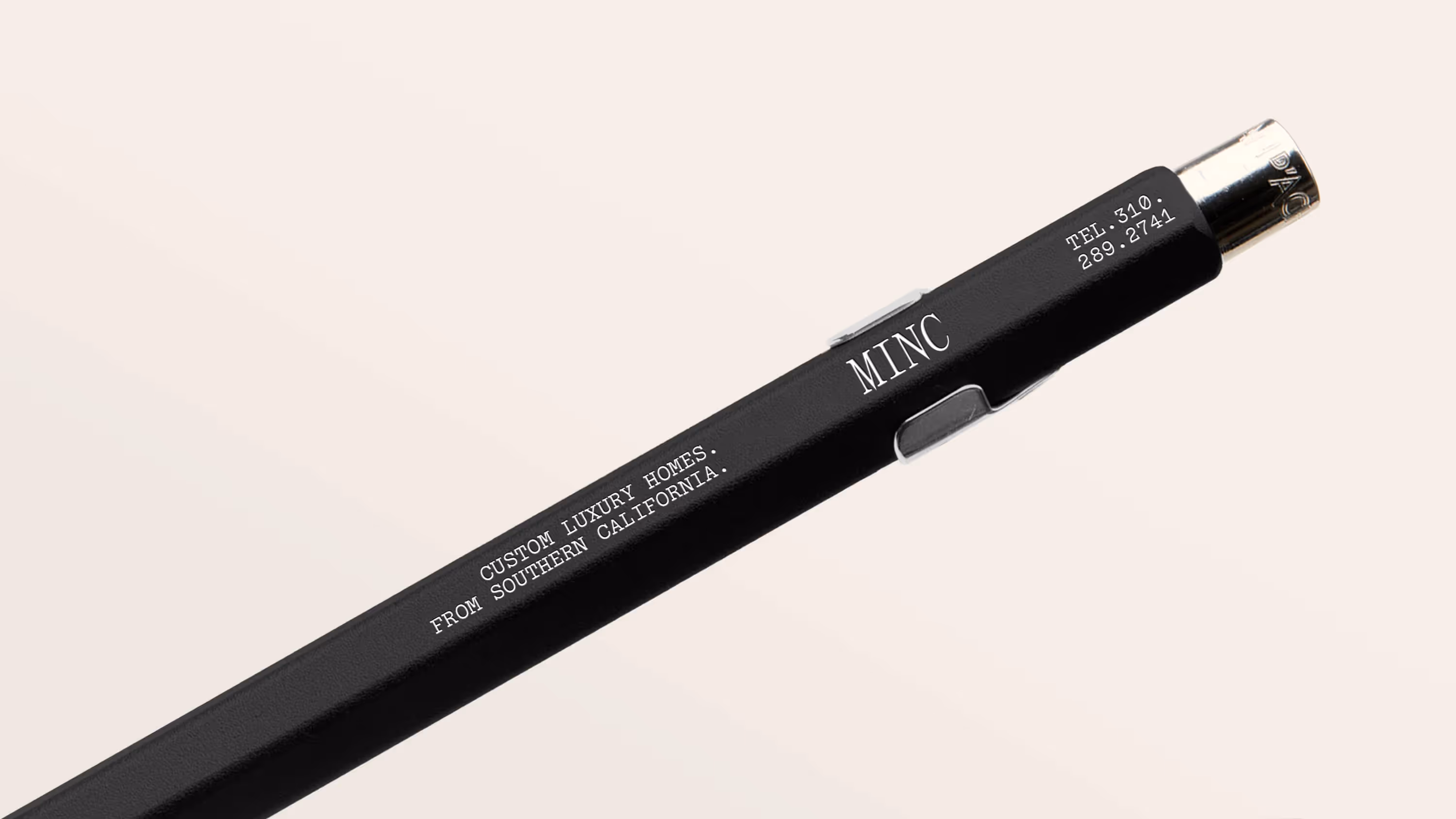 A Minc-branded pen that displays the logo, tagline, and phone number.