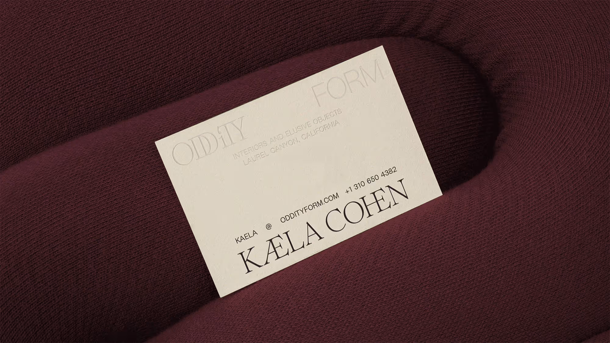 A branded business card posed on a couch.
