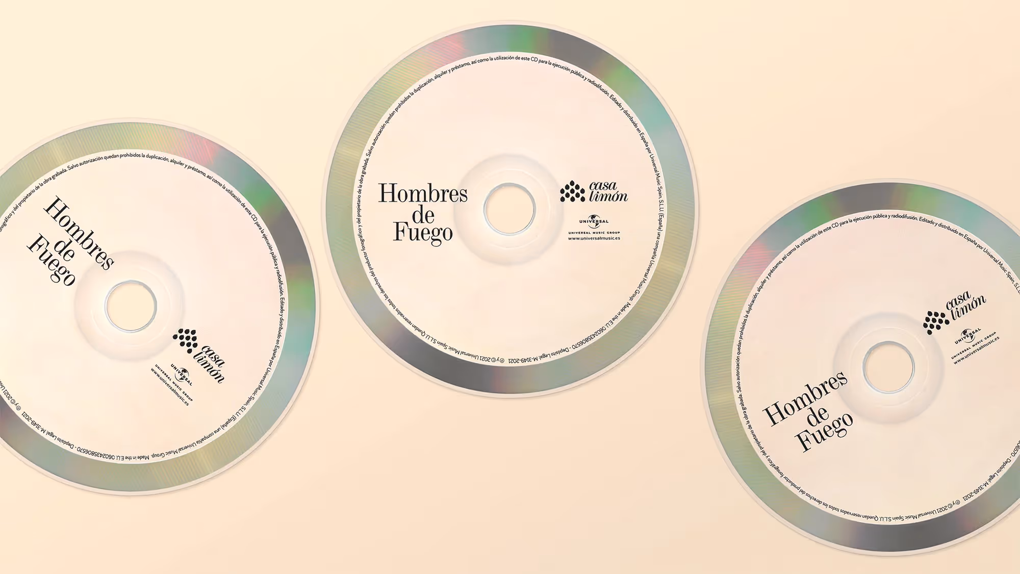 Three CDs on a flat off-white background.