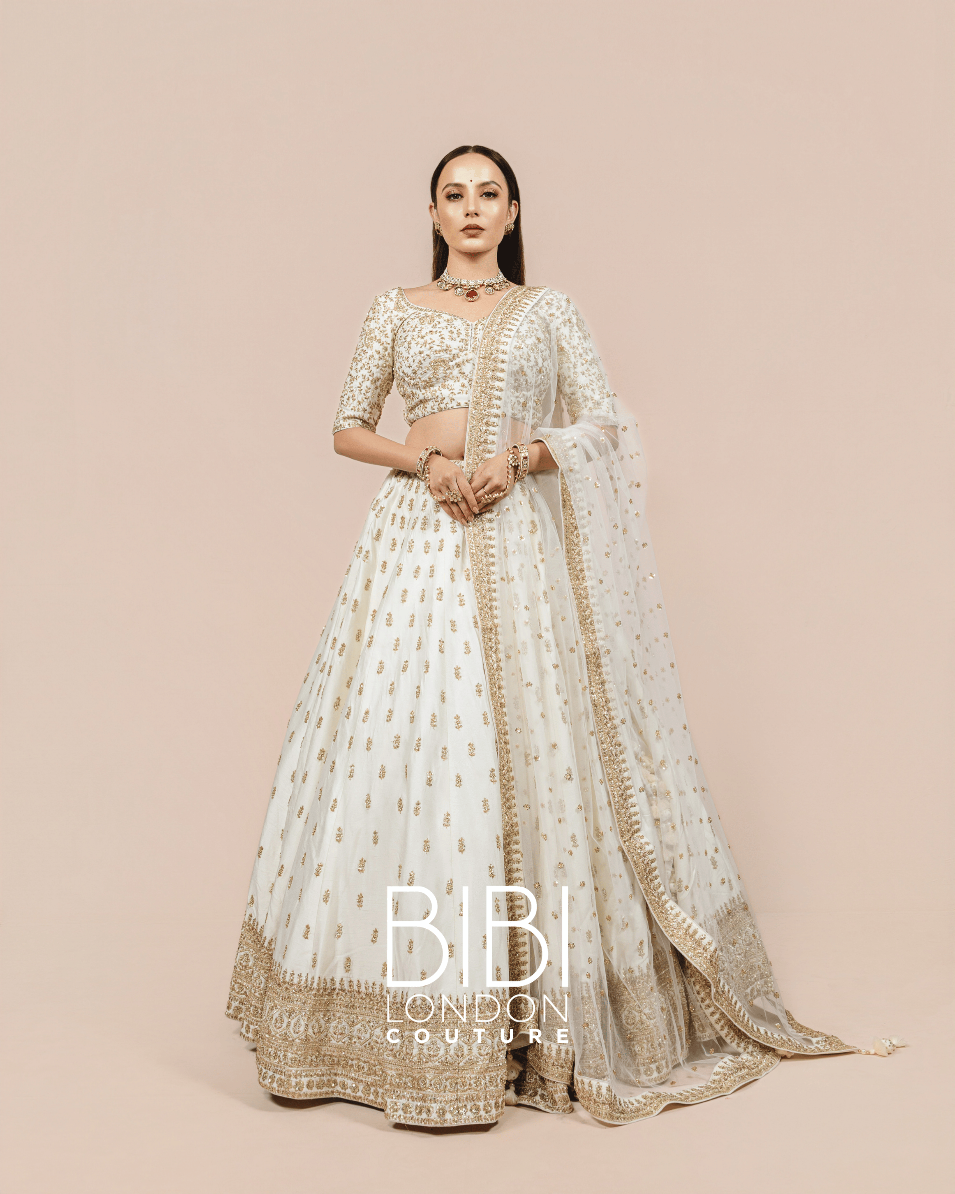 Ivory Lehenga with Gold Sequin Bootis and Embroidered Borders