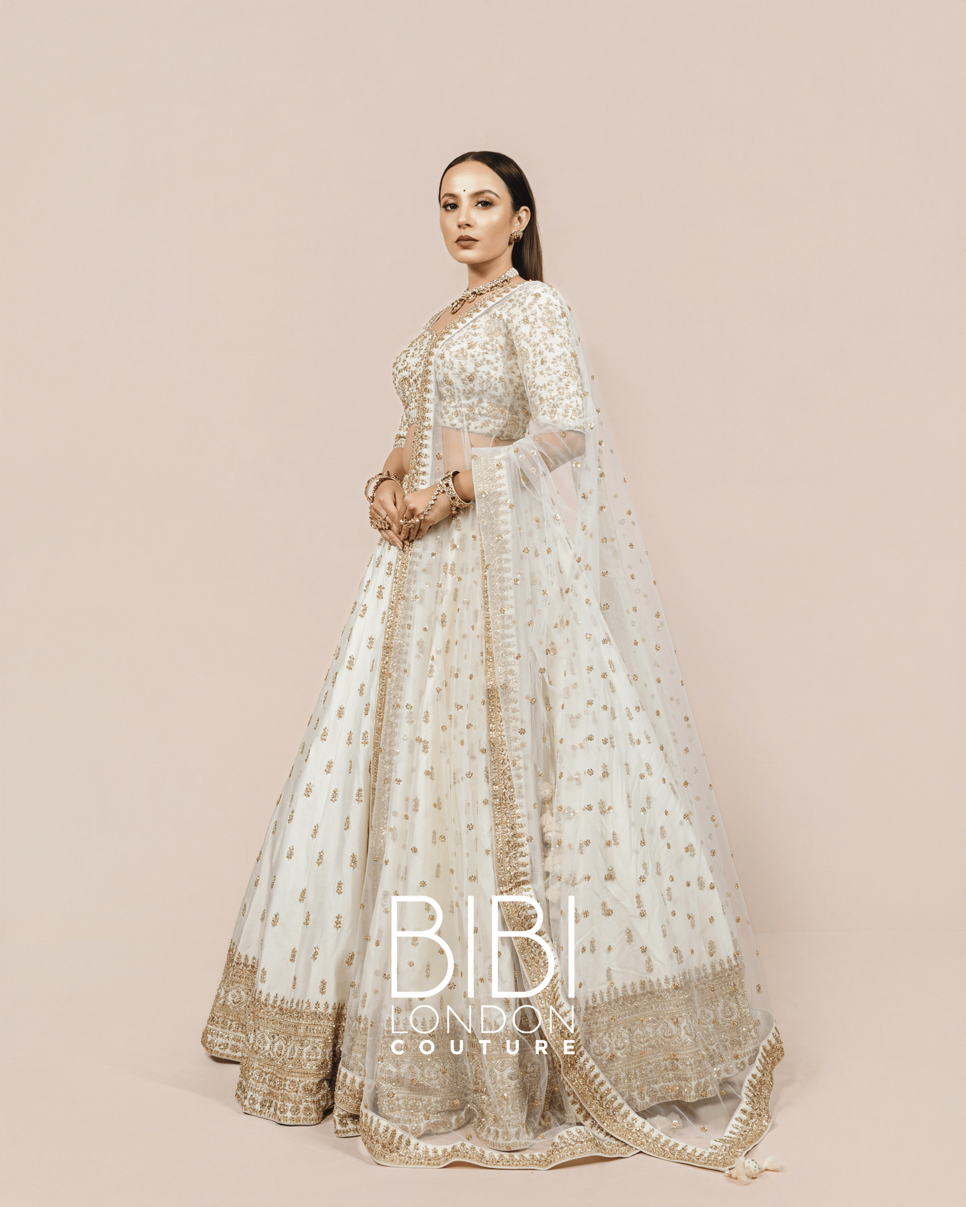 Ivory Lehenga with Gold Sequin Bootis and Embroidered Borders