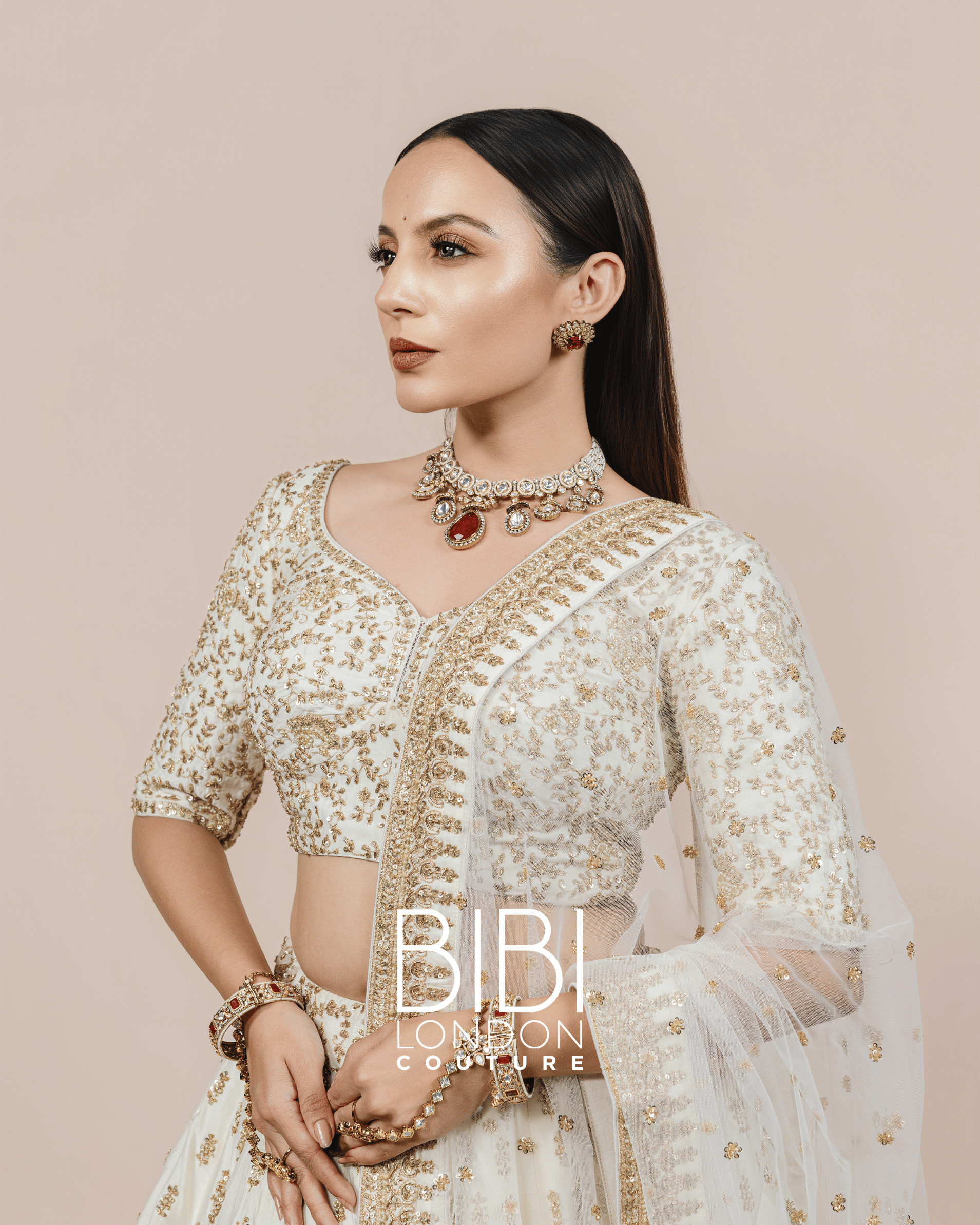 Ivory Lehenga with Gold Sequin Bootis and Embroidered Borders