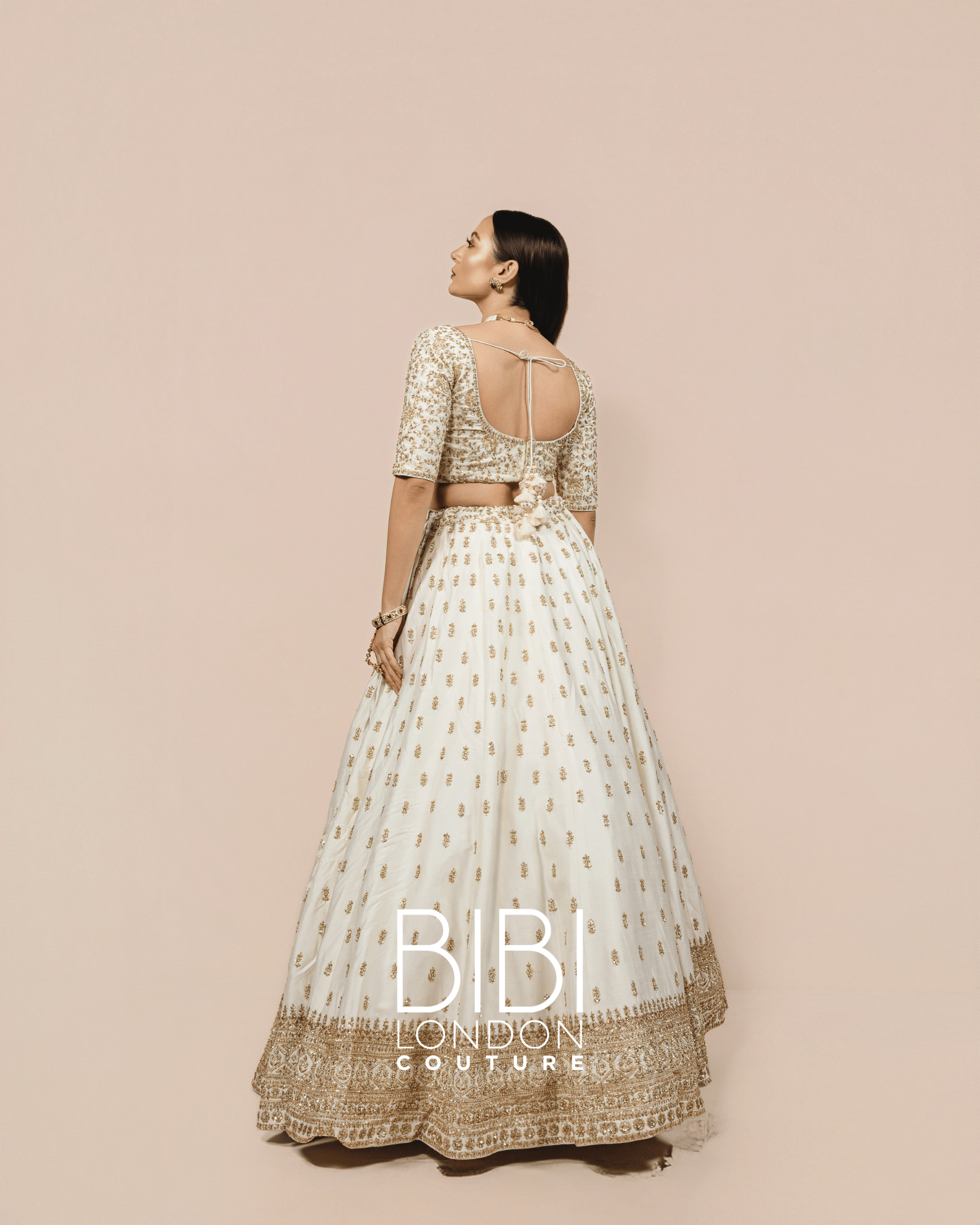 Ivory Lehenga with Gold Sequin Bootis and Embroidered Borders