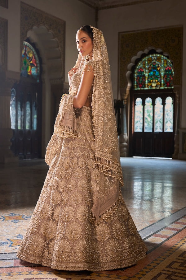 Champagne Gold Bridal Lehenga with Pearl Tassel Blouse and Ornate Floral Embroidery