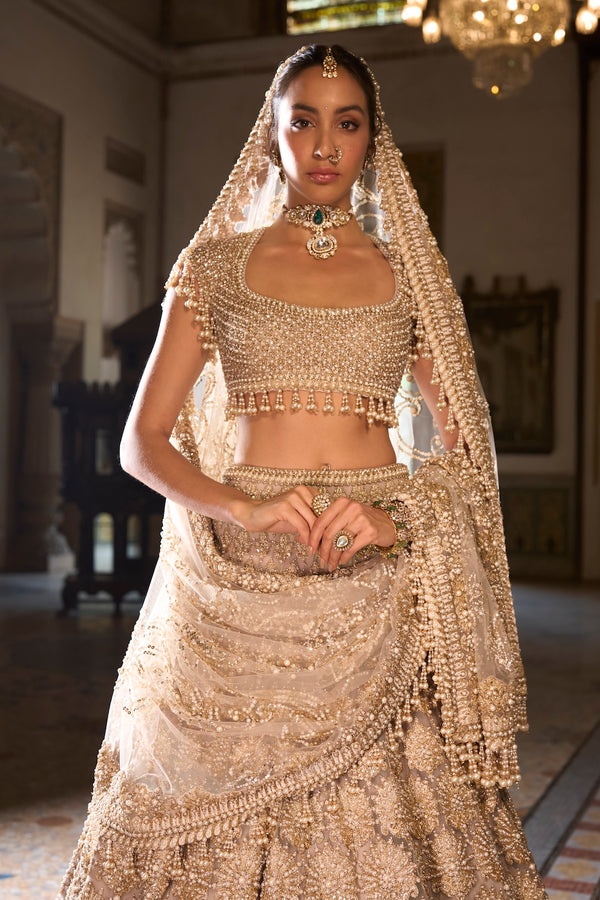 Champagne Gold Bridal Lehenga with Pearl Tassel Blouse and Ornate Floral Embroidery