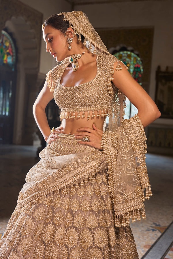 Champagne Gold Bridal Lehenga with Pearl Tassel Blouse and Ornate Floral Embroidery