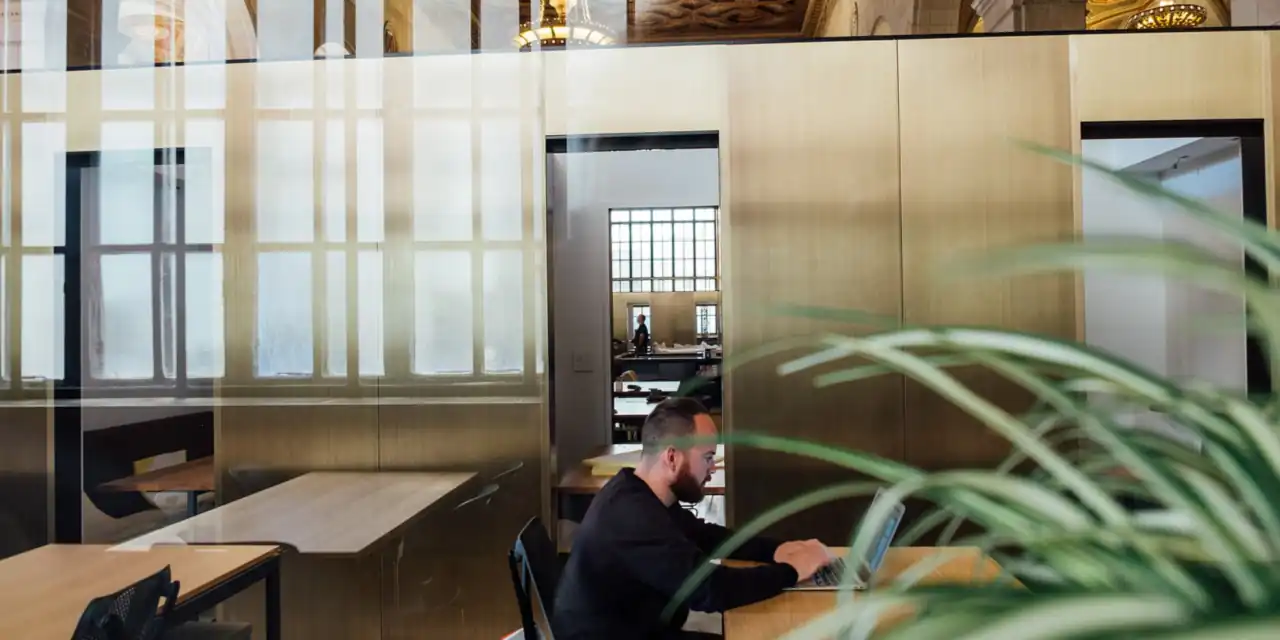Workspace in an open office behind a glass wall