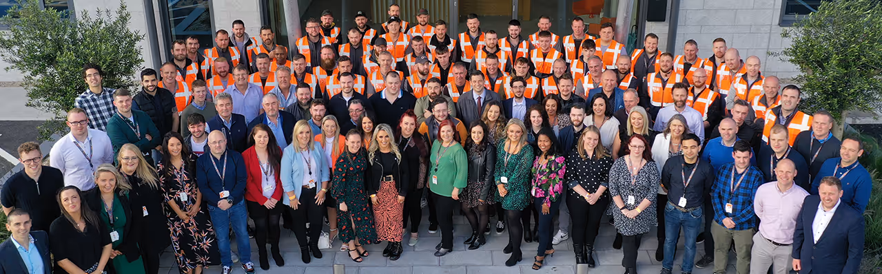Large group photo of Activ8 Solar Energies staff gathered outside company headquarters including office and installation teams