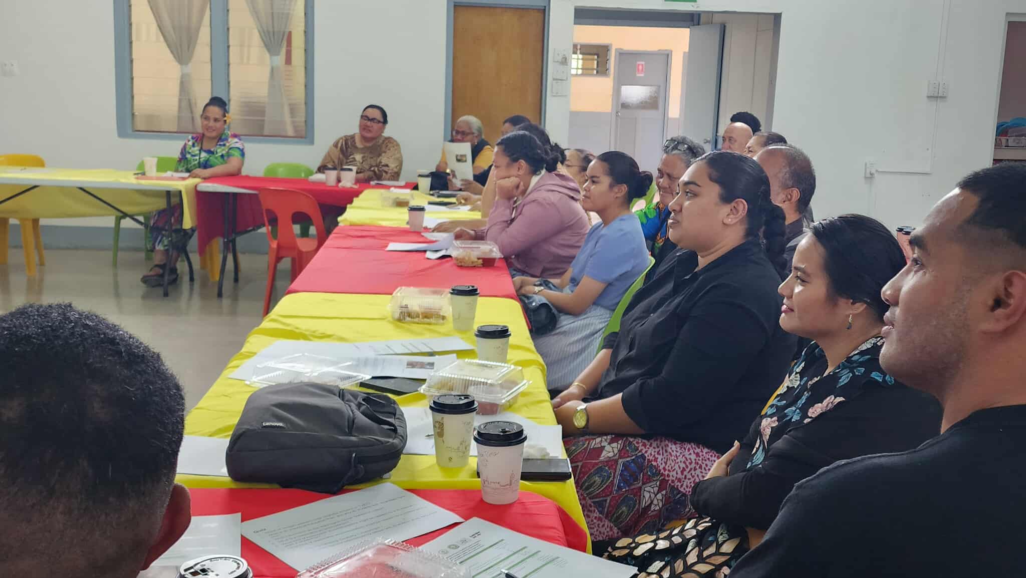 Participants listening and taking notes during the workshop