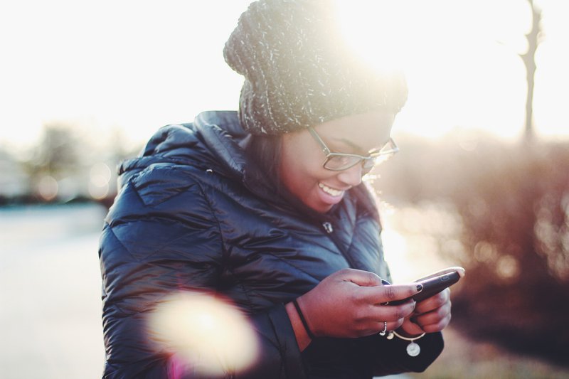 woman enjoying social media on mobile phone