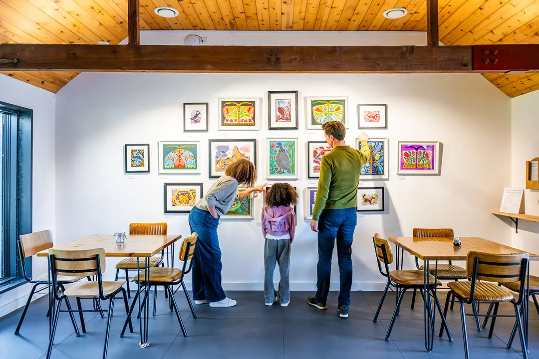 Family viewing the art exhibition at Stapleford Granary, Cambridgeshire.