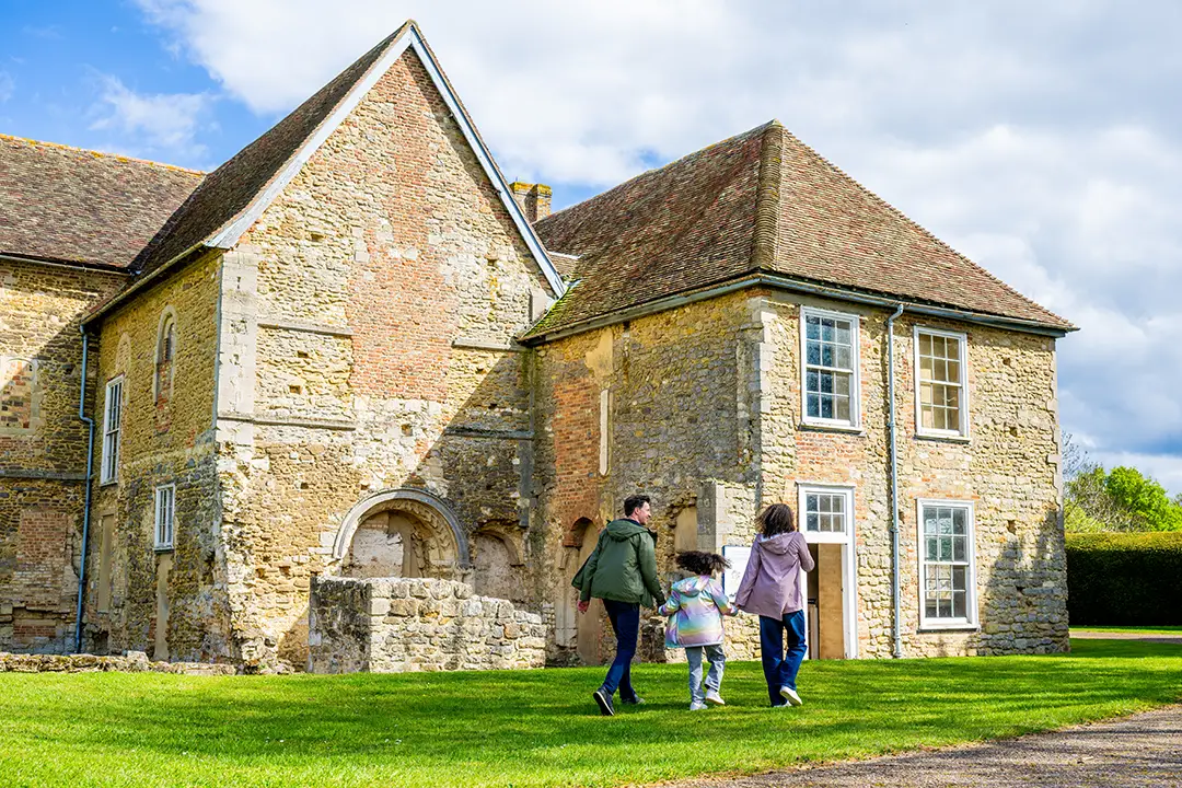 A Family walking up to a building at Denny Abbey & The Farmland Museum, Waterbeach, Cambridgeshire.