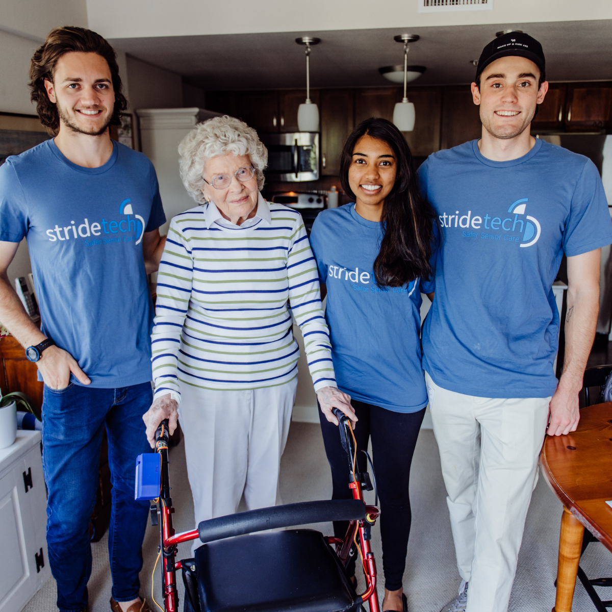 StrideTech founders with a client using a walker