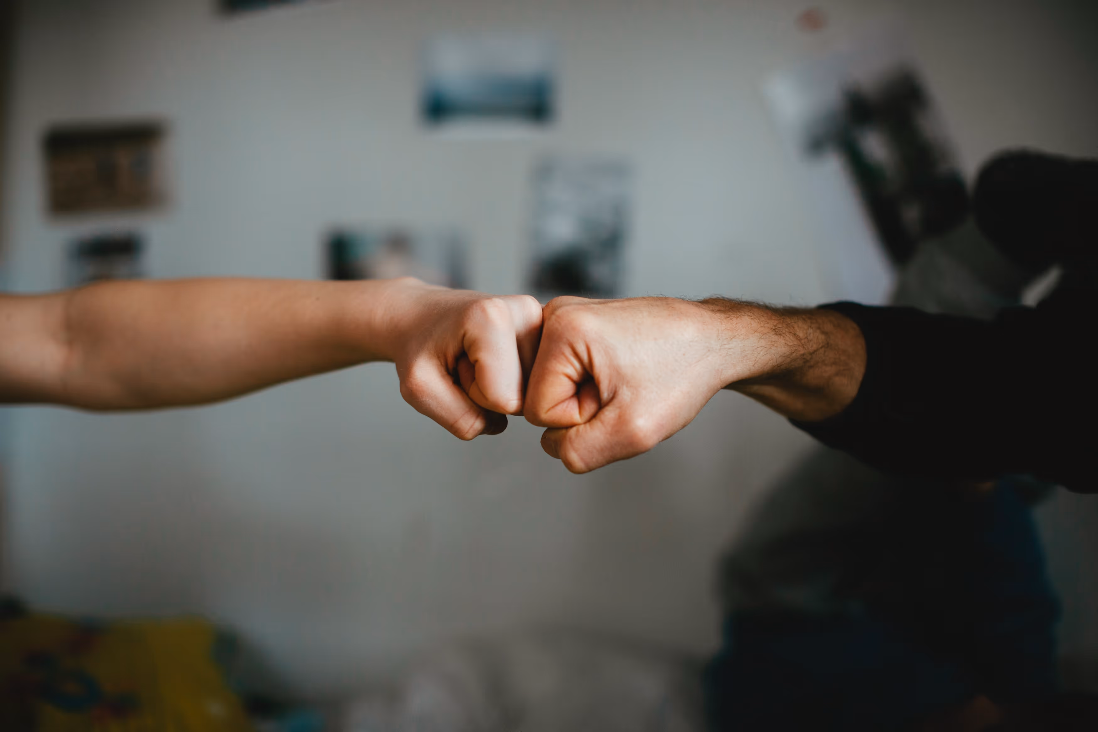 two people fist bumping.