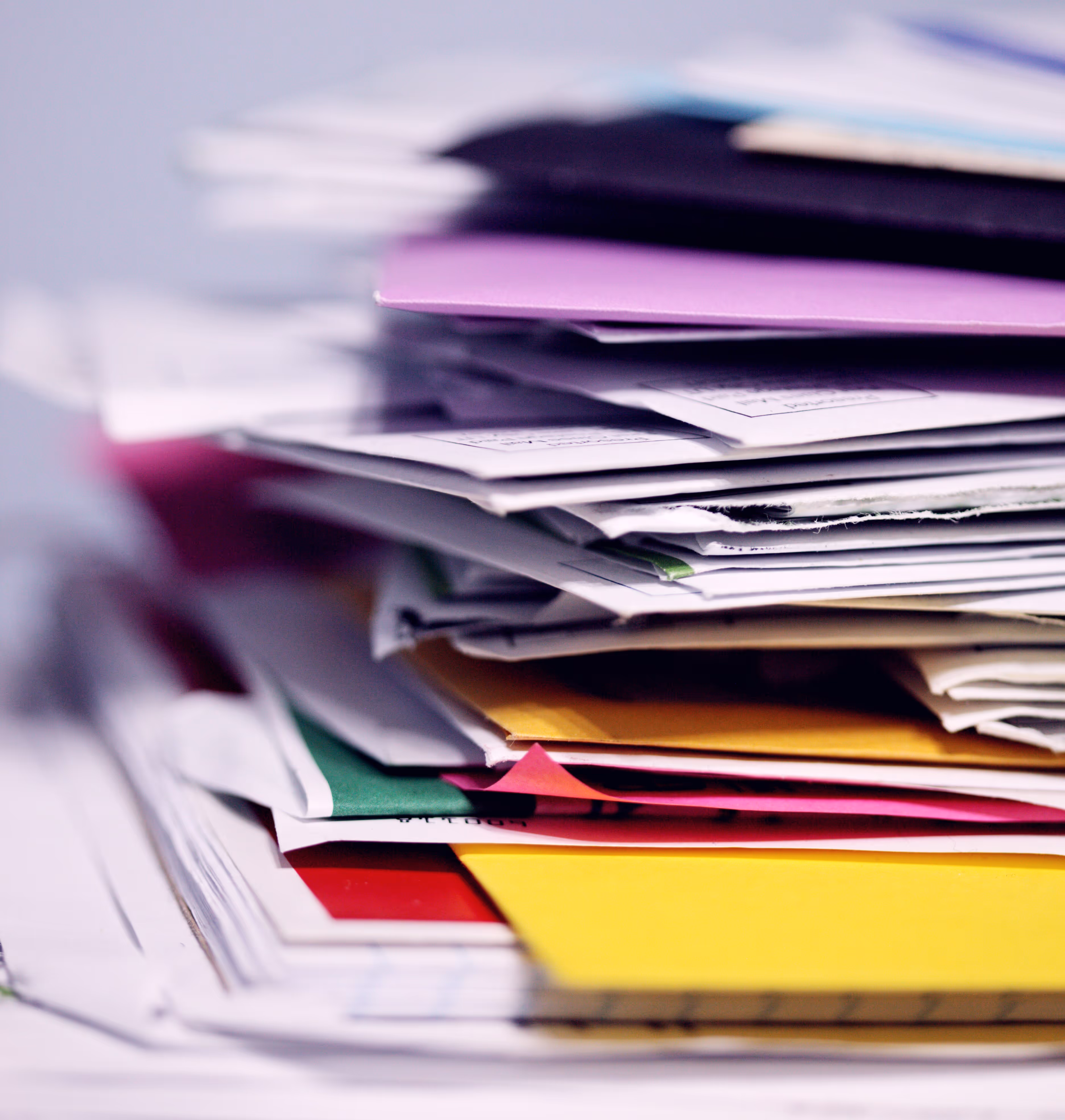 A stack of papers, notebooks, and folders.