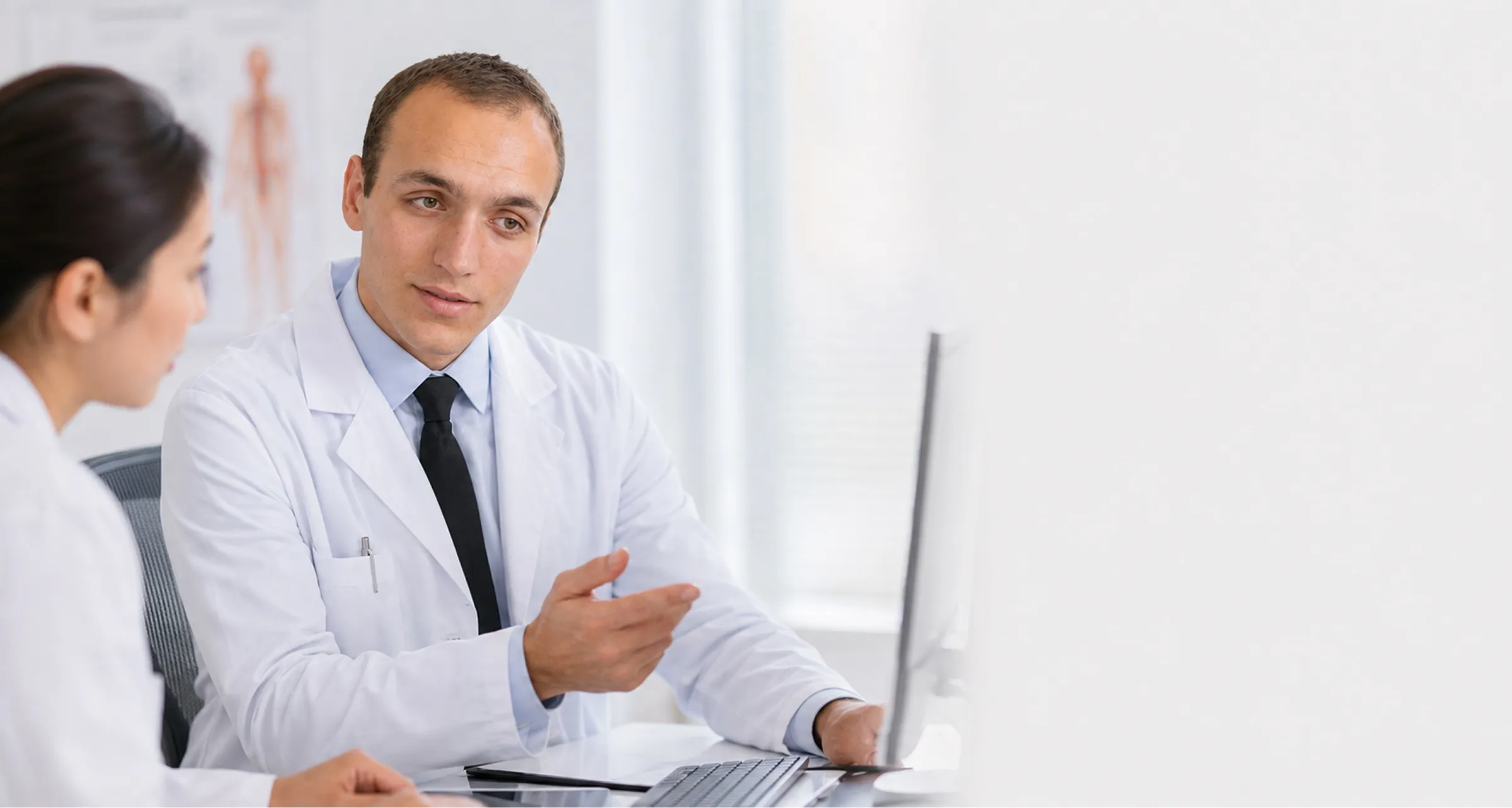 Dr. Phillip Ulyanovskiy consulting with a patient