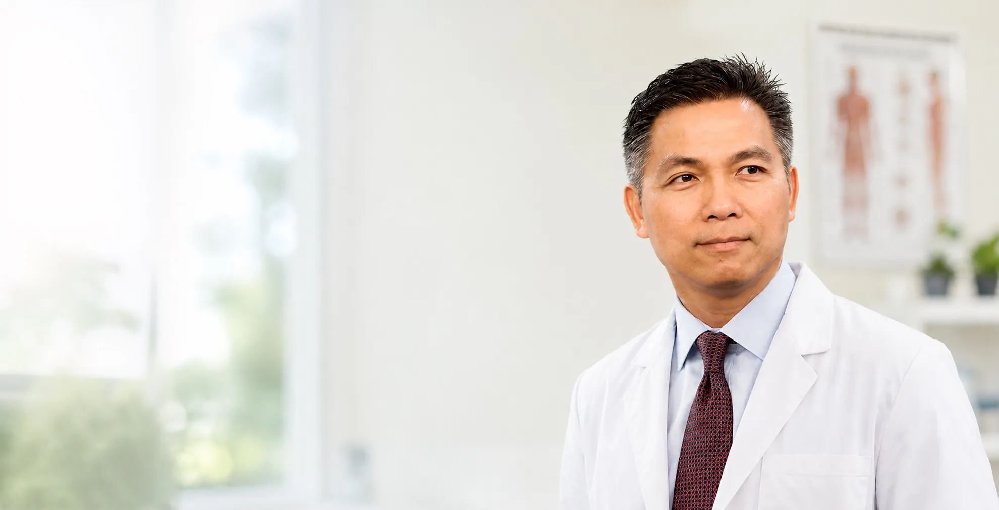 Dr. Alan Tran, MD in his clinic