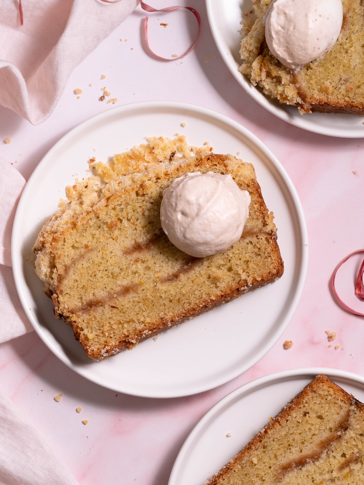 Slices of rhubarb crumble cake on white plates