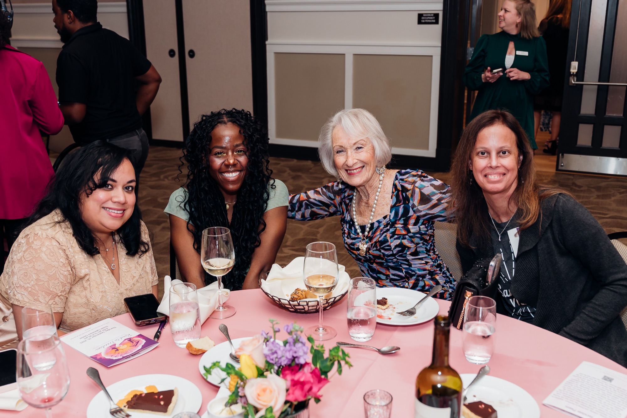 Road to Freedom Gala, guests smiling together at their table