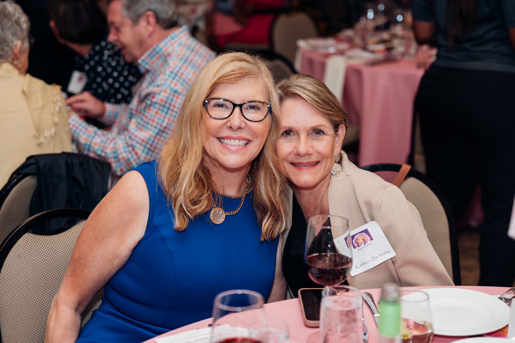 Road to Freedom Gala, two guests smiling at their table