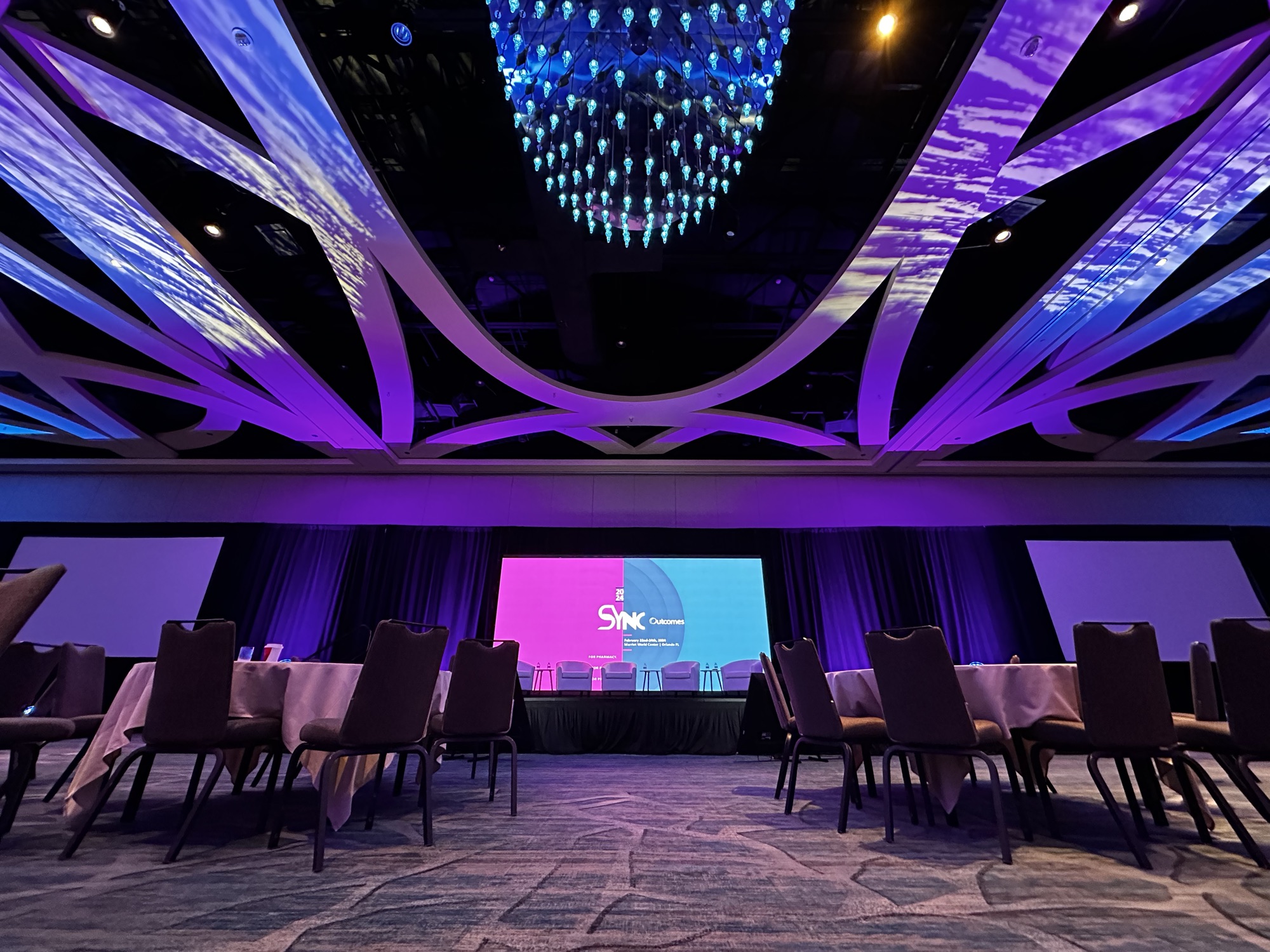 Outcomes SYNC Conference, projection screen and stage lighting