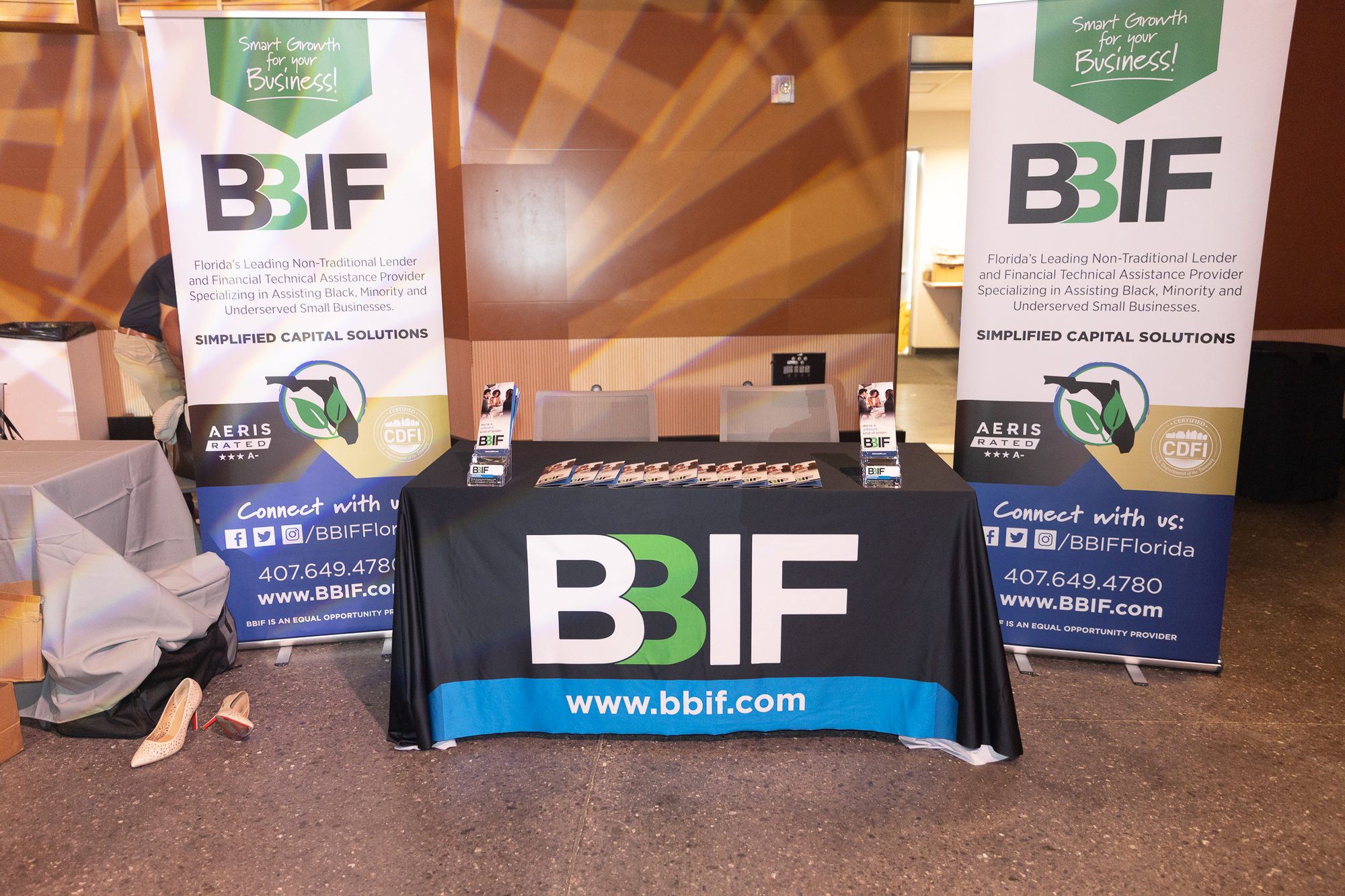 A sponsor's exhibitor table with branded signage at the Empowerment Business Conference