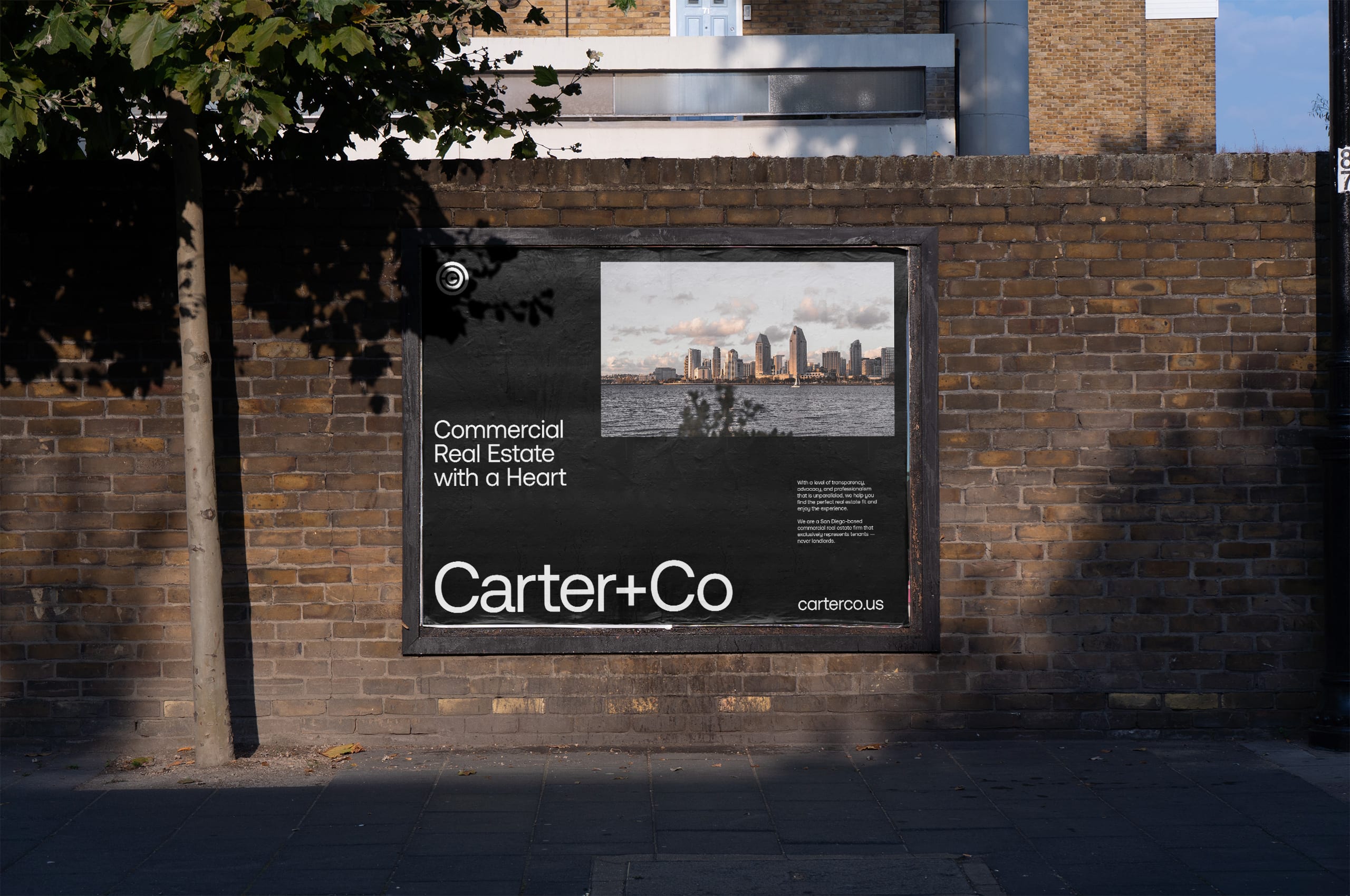 Carter+Co poster on a brick wall reading Commercial Real Estate with a Heart