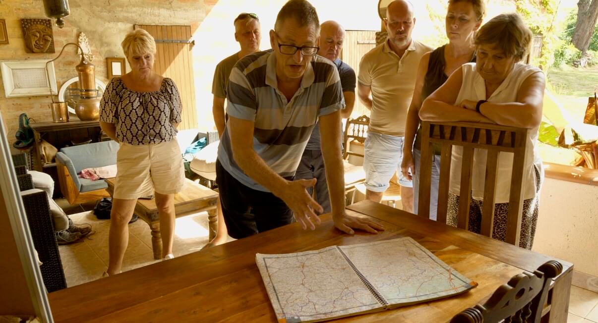 A group of people looking at a map on a table.