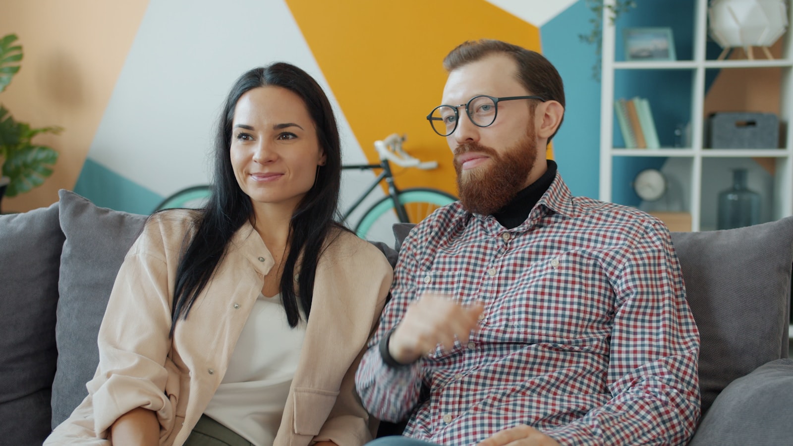 Young couple relaxing together on a couch at home