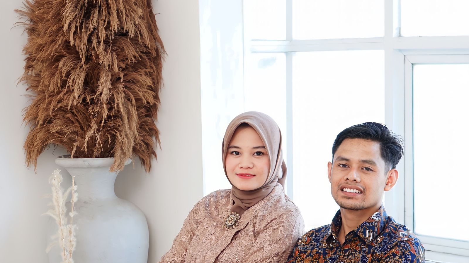 Asian couple sitting on sofa at home, peaceful moment